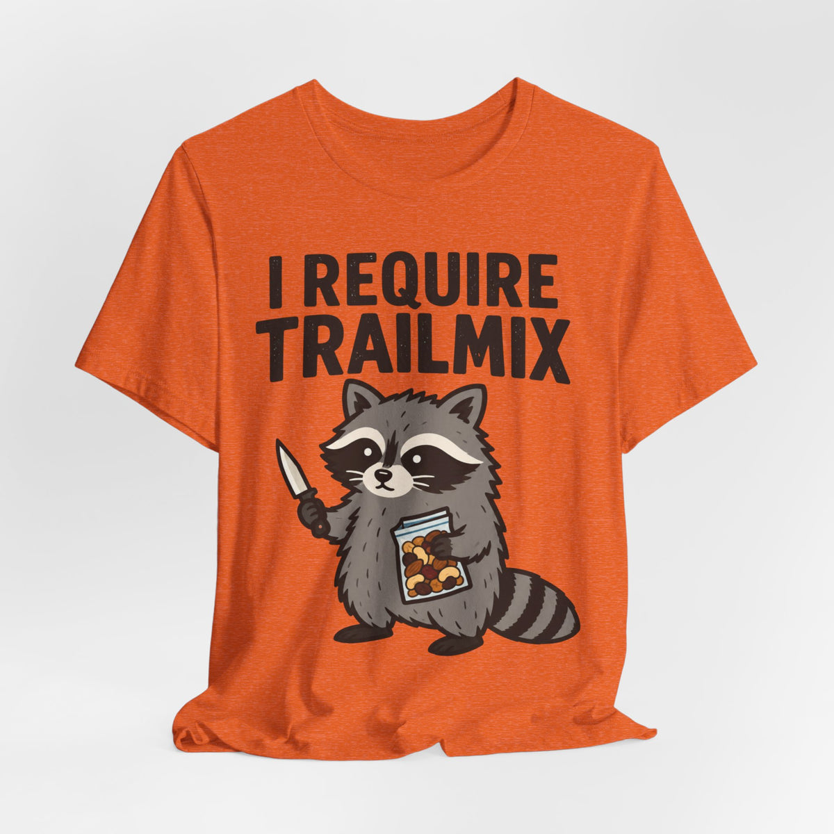 I Require Trailmix Raccoon T-Shirt in Heather Orange - funny goblincore raccoon trail mix graphic tee, Barely Outdoorsy Bella Canvas 3001