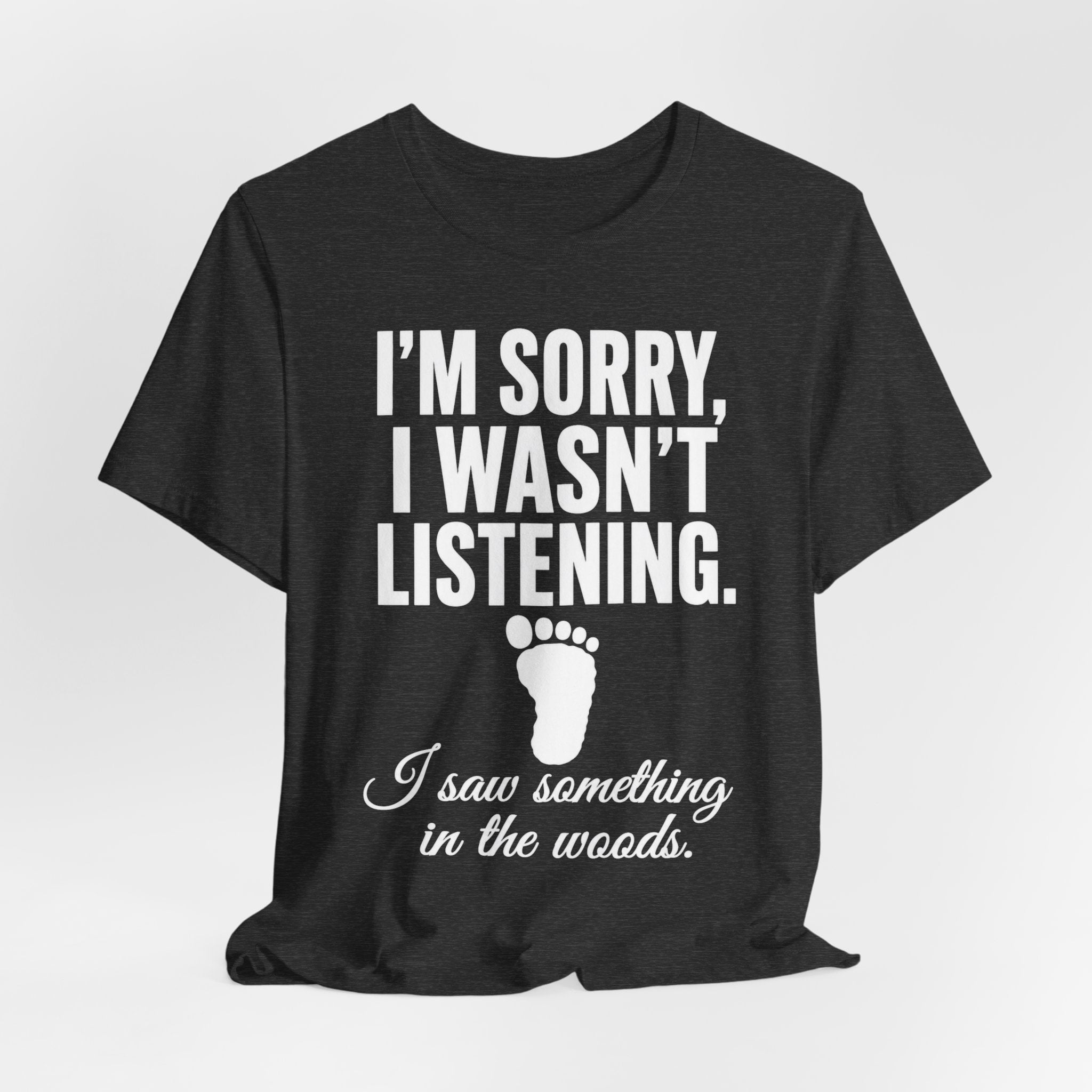 I Saw Something In The Woods T-Shirt in Black Heather - bold Bigfoot footprint cryptid tee, Barely Outdoorsy
