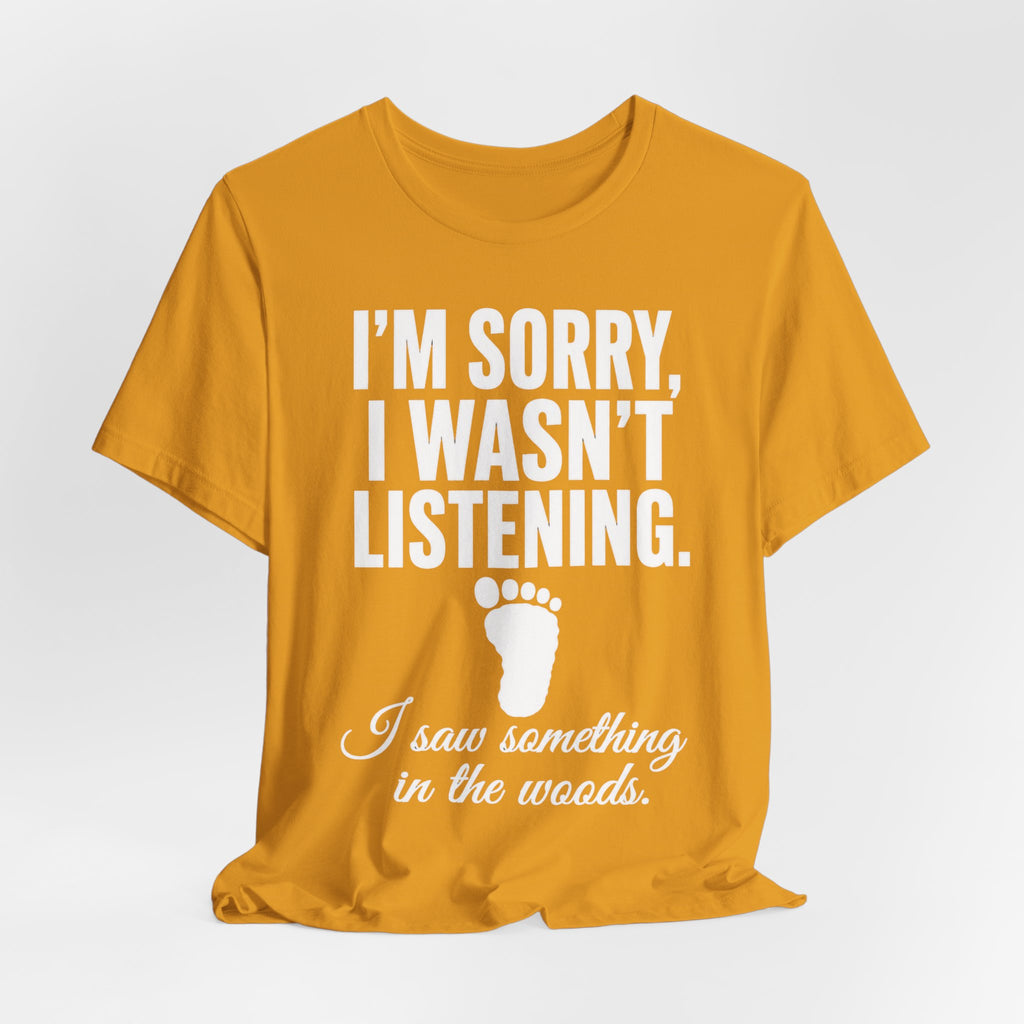 I Saw Something In The Woods Tee flat lay Dark Grey Heather - unisex crew neck Bigfoot footprint graphic tee, Barely Outdoorsy
