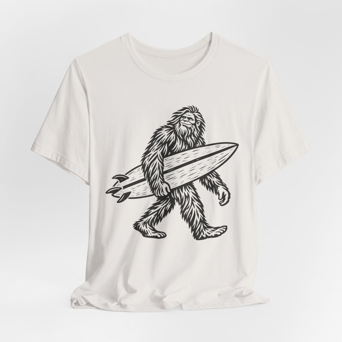 Surfing Bigfoot T-Shirt in Heather Tan - funny Sasquatch surf graphic tee, Barely Outdoorsy Bella Canvas