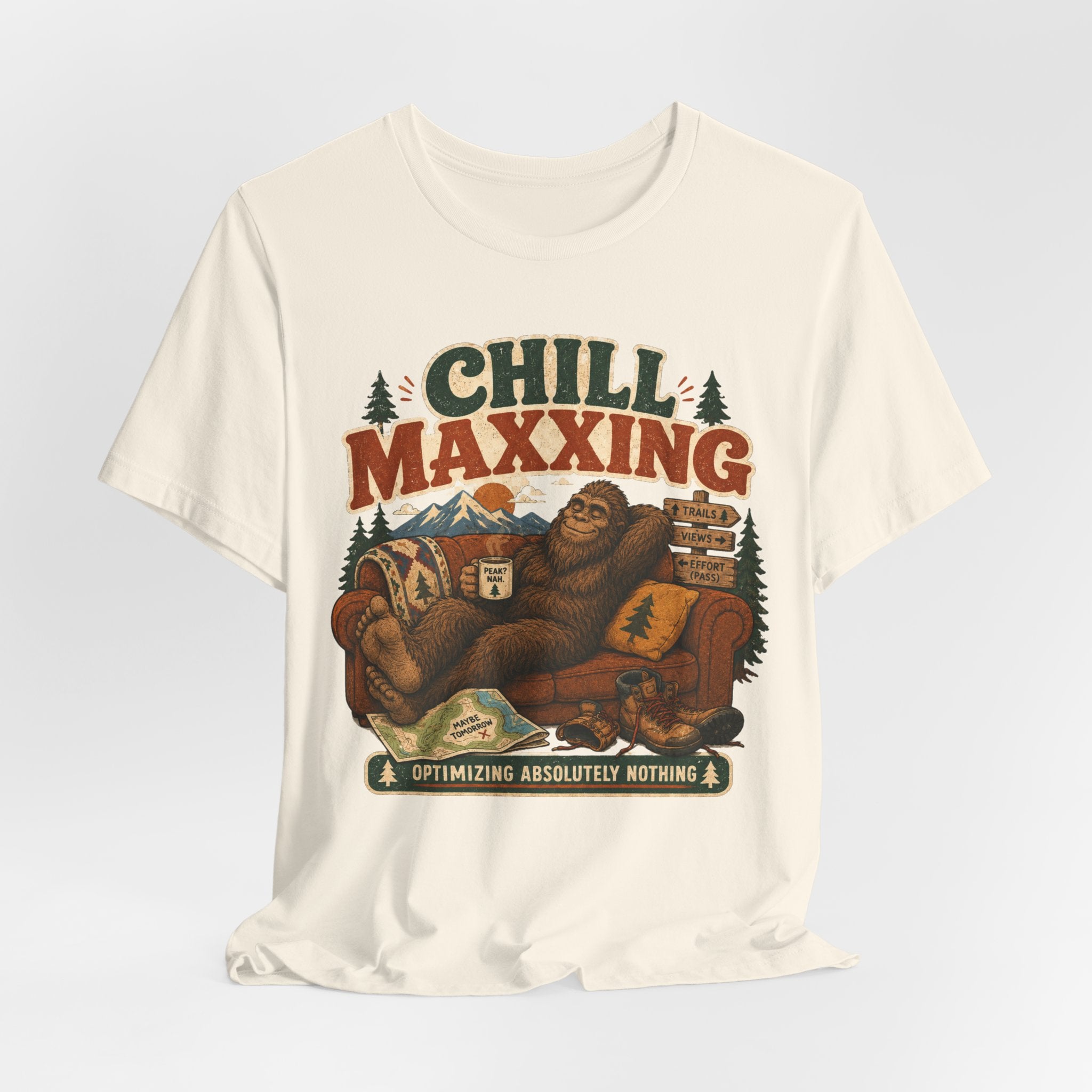 Flat lay of Barely Outdoorsy Chill Maxxing Bigfoot tee, white unisex crew neck, Bella Canvas 3001