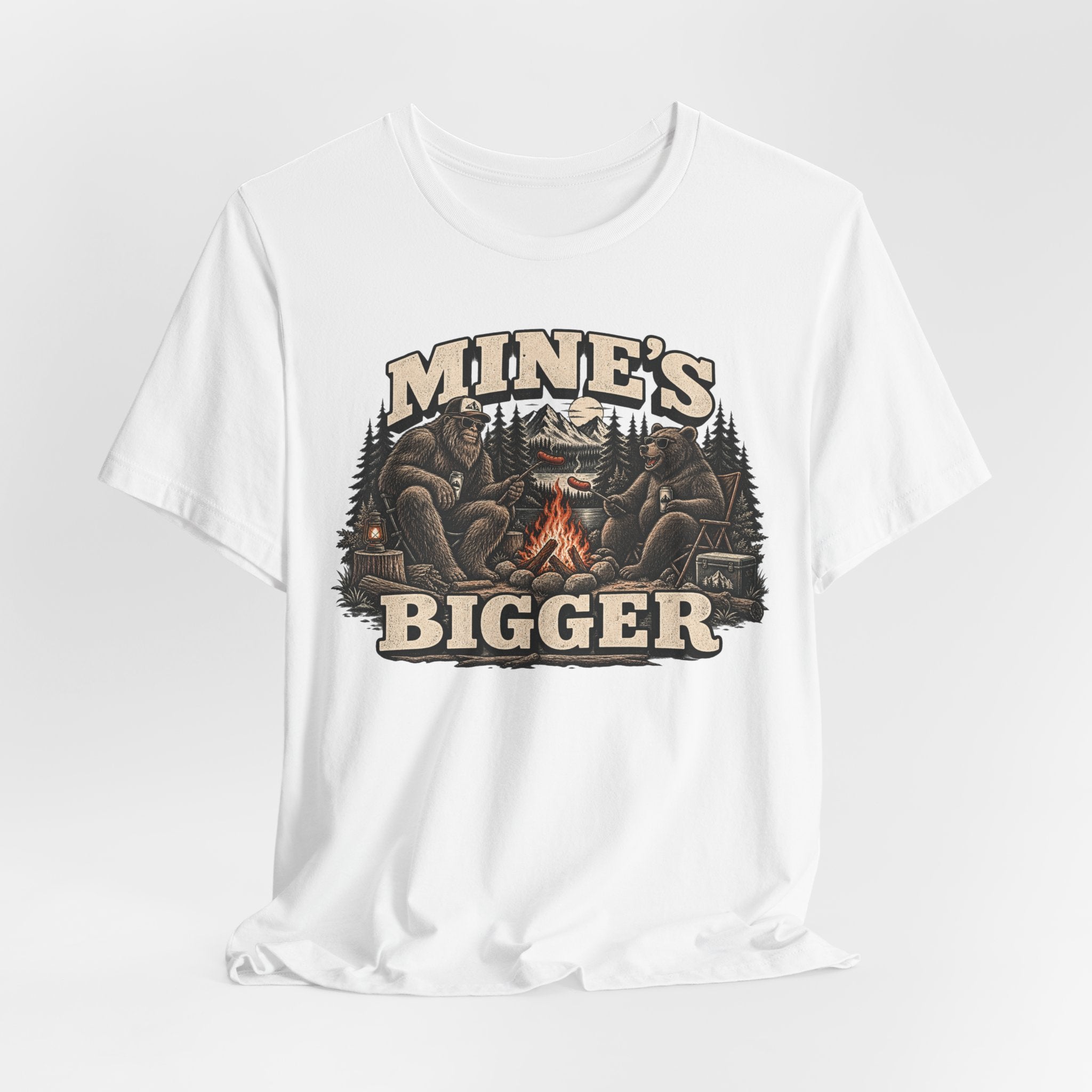 Mine's Bigger Funny Bigfoot T-Shirt in Black worn shot - funny Bigfoot campfire shadow humor tee, Barely Outdoorsy Bella Canvas