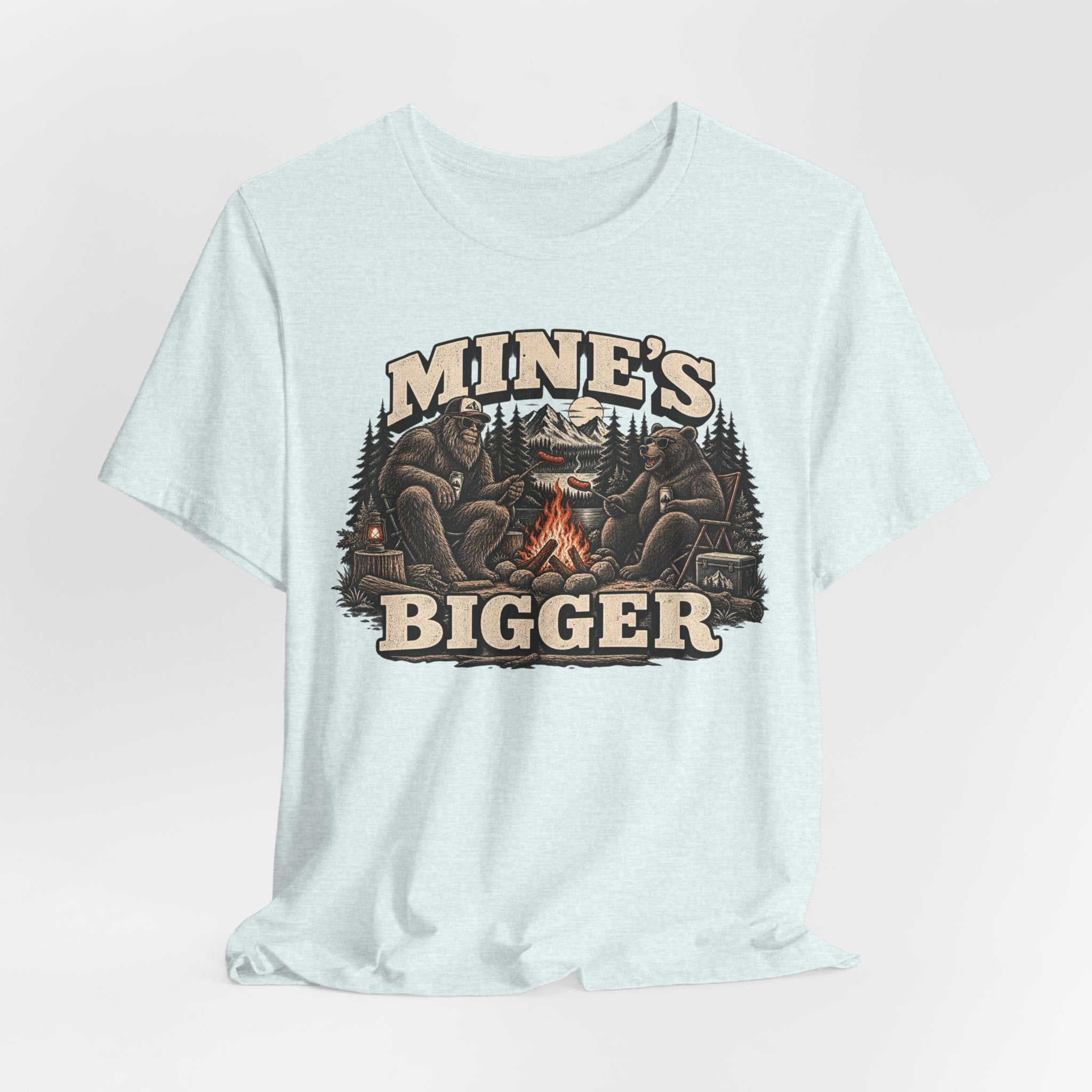 Mine's Bigger Funny Bigfoot T-Shirt in Heather Ice Blue - funny Bigfoot campfire shadow graphic tee, Barely Outdoorsy