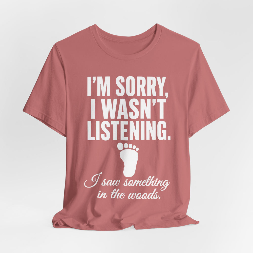 I Saw Something In The Woods Tee in Red - cryptid footprint statement humor shirt, Barely Outdoorsy Bella Canvas