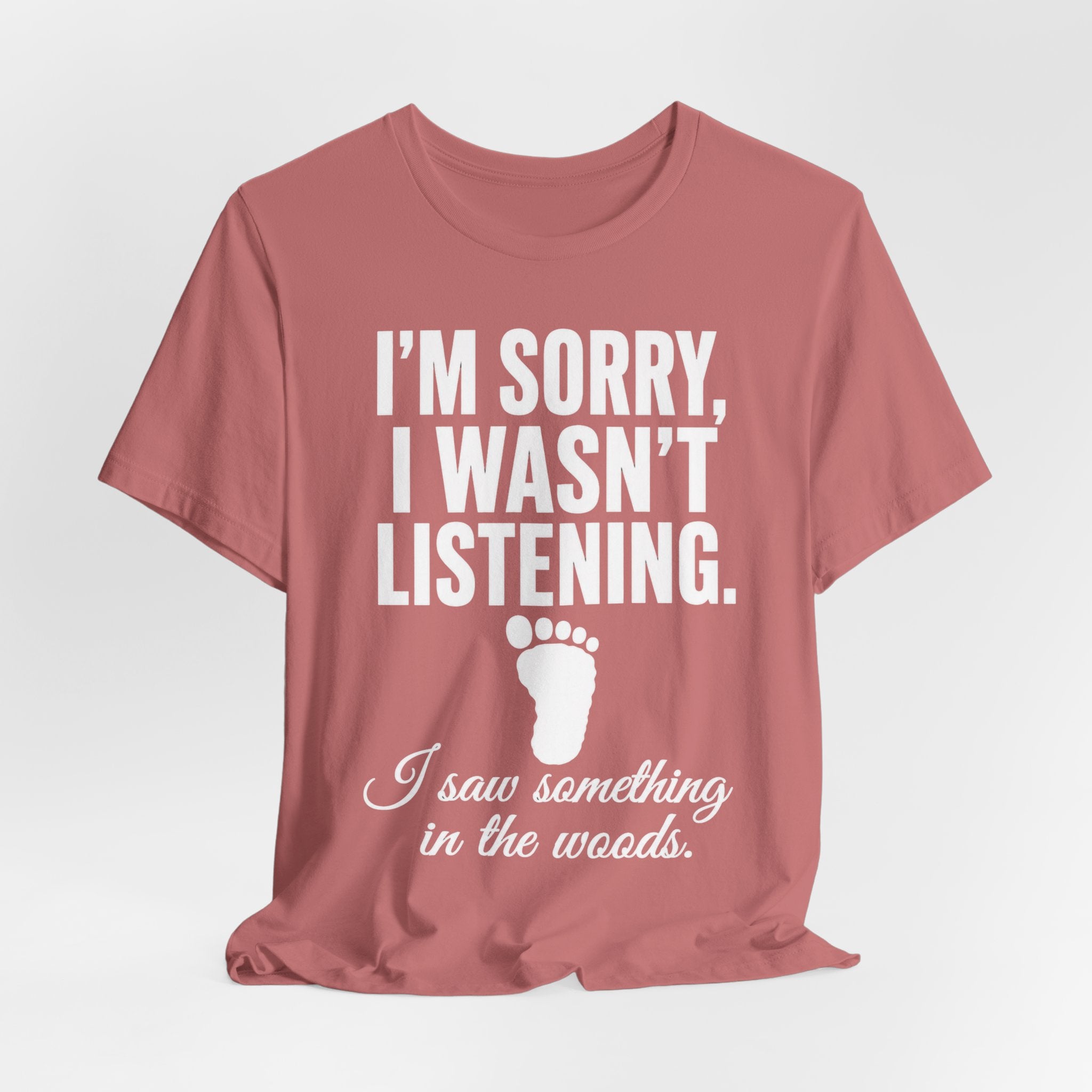 I Saw Something In The Woods Tee in Red - cryptid footprint statement humor shirt, Barely Outdoorsy Bella Canvas