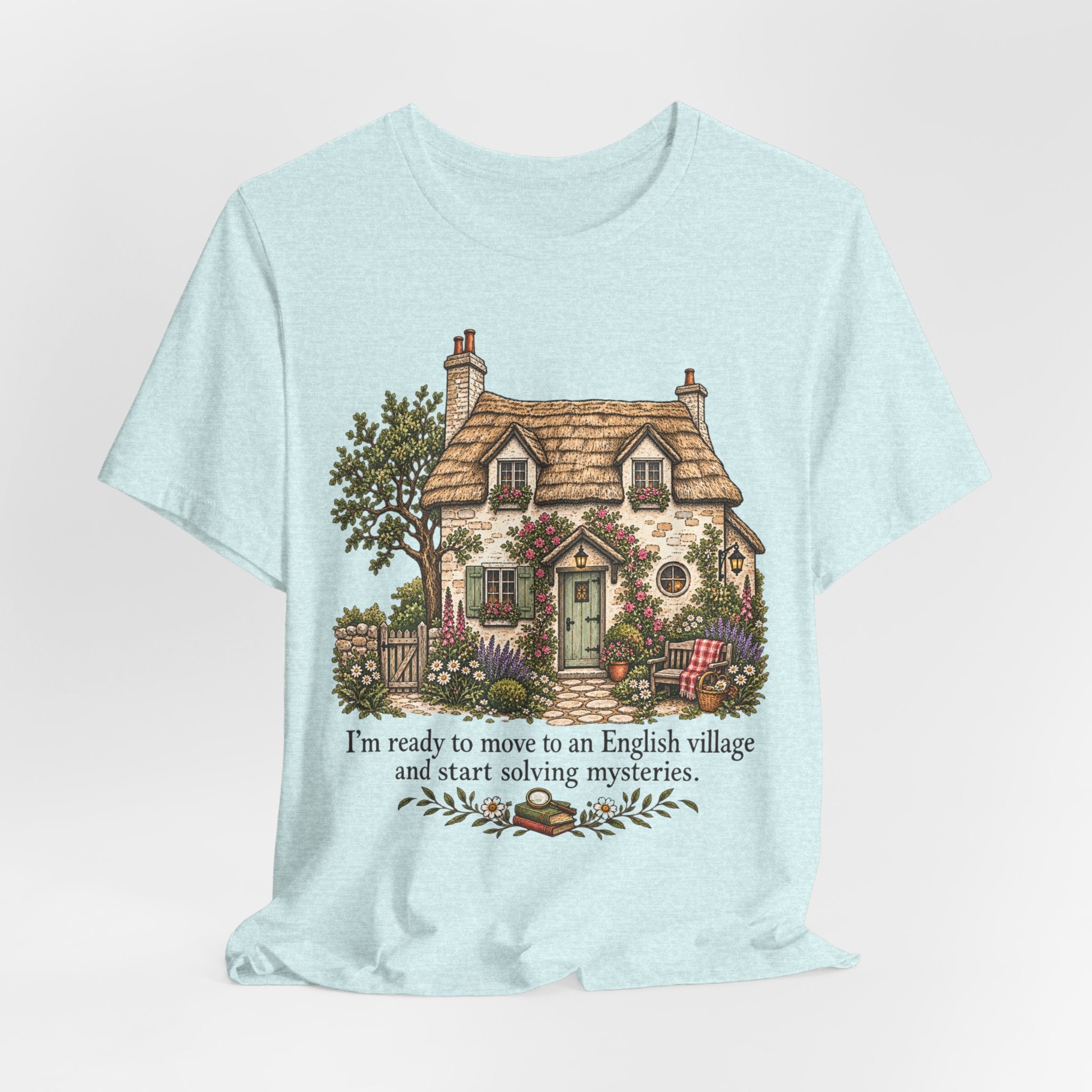 English Village Mysteries Funny Cozy T-Shirt in Heather Peach worn shot - cottagecore village mystery humor shirt, Barely Outdoorsy Bella Canvas