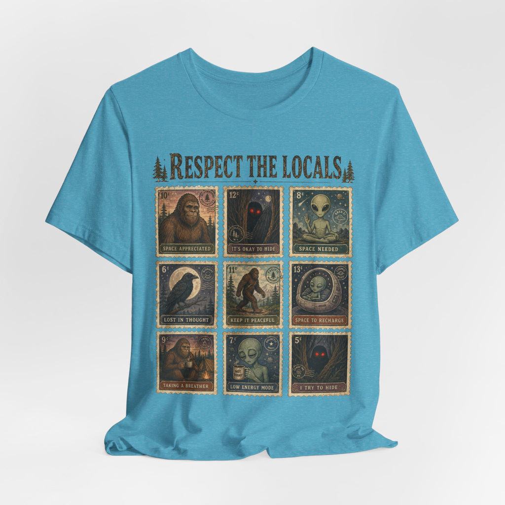 Person wearing white Respect The Locals cryptid postage stamp graphic tee outdoors, funny introvert bigfoot alien shirt
