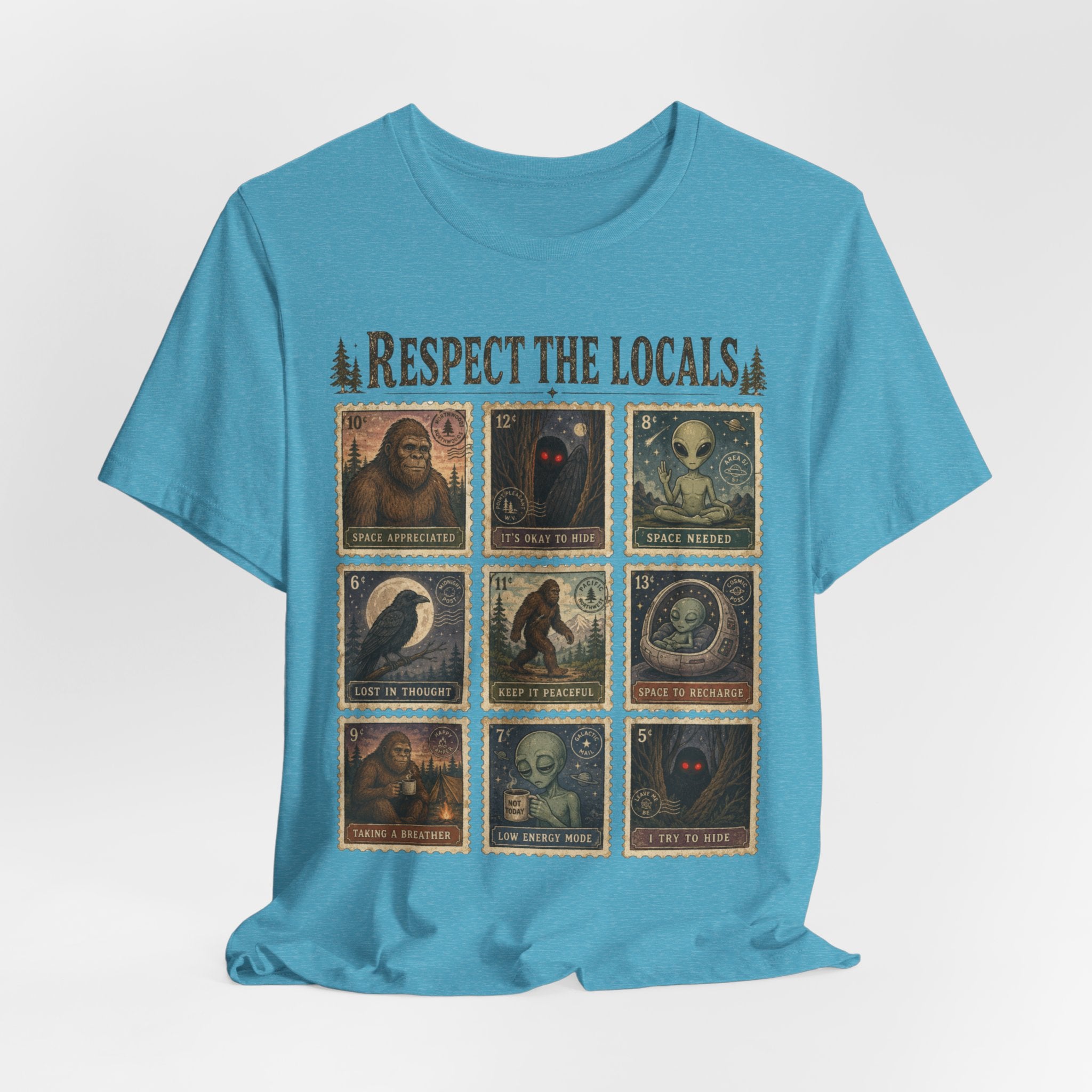 Person wearing white Respect The Locals cryptid postage stamp graphic tee outdoors, funny introvert bigfoot alien shirt