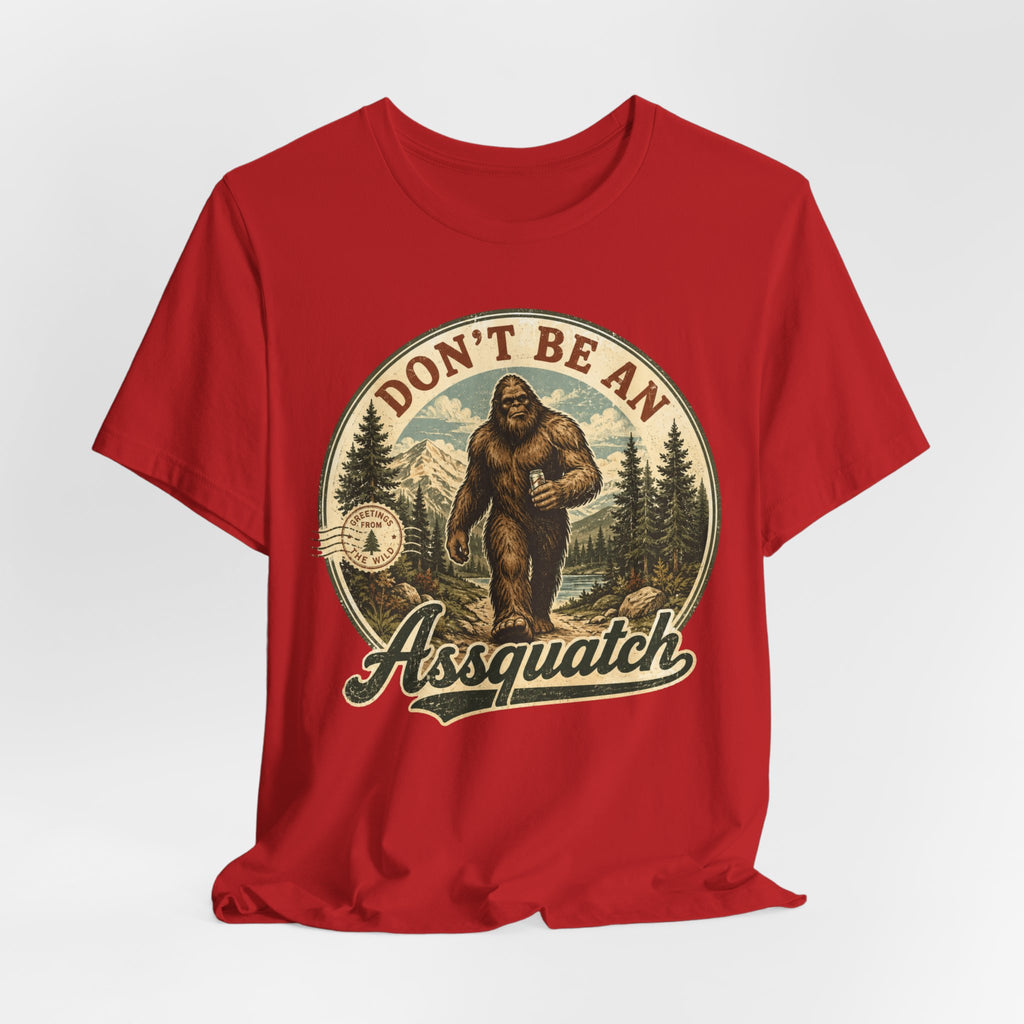 Don't Be An Assquatch Funny Bigfoot T-Shirt flat lay Athletic Heather - unisex crew neck Sasquatch pun graphic tee, Barely Outdoorsy