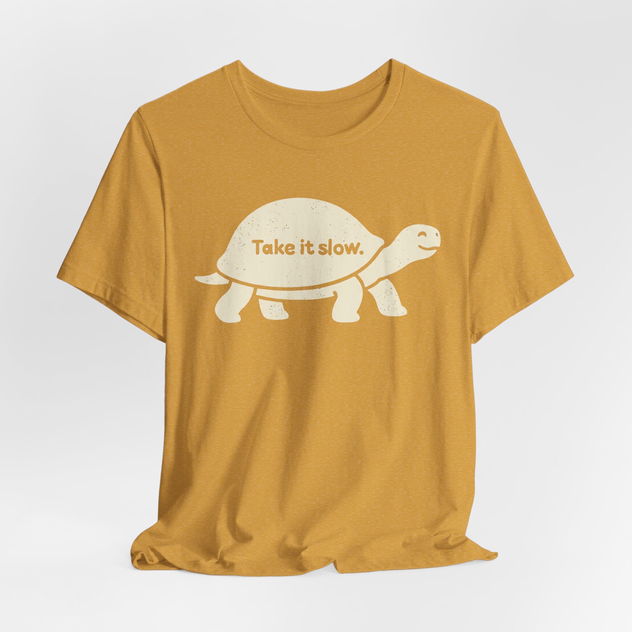 Take It Slow T-Shirt in Heather Green detail - simple line art smiling turtle close-up graphic