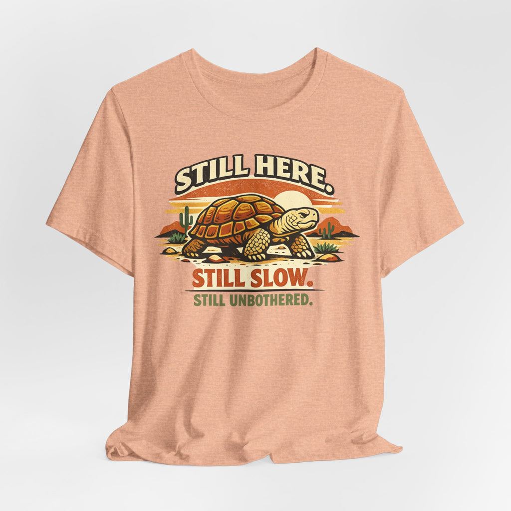 Still Here Still Slow Still Unbothered T-Shirt in Heather Peach detail - tortoise unbothered humor close-up, Barely Outdoorsy